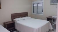 a bedroom with a white bed and a window at Imbau Palace Hotel in Imbau