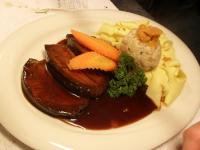 a plate of food with meat and vegetables and gravy at Solhof-Schömberg in Loßburg