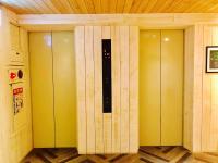 a row of yellow elevator stalls in a room at Ahiruyah Guesthouse in Kaohsiung