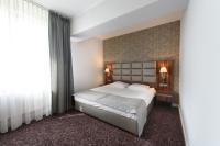 a bedroom with a large bed and a large window at Hotel Nowy Dwór in Trzebnica