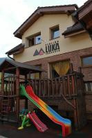 a playground with a slide in front of a building at Penzión Luka in Terchová