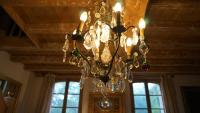 a chandelier hanging from a ceiling in a room at Les Hotes Des Guillemets in Laglorieuse
