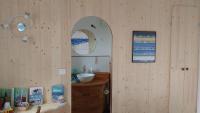 a bathroom with a sink and a mirror at Les Chênes Bleus in Sainte-Marie-de-Ré