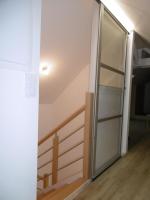 a sliding glass door in a room with a staircase at Le petit domaine des Aubuis in Chinon