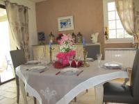 a table with a white table cloth and flowers on it at L&#39;Oustau de Bigatié in Lambesc