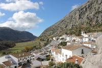 a village on the side of a mountain at Apartamentos Buganvilla in Villaluenga del Rosario