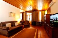 a living room with a couch and a flat screen tv at Parador Casa Da Insua in Penalva do Castelo