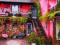 a pink house with a staircase in front of it at Tilly&#39;s B&amp;B and apartment house in Le Hohwald