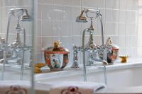 a bathroom sink with two faucets and vases on it at Chambre d&#39;hôtes Château Gigognan in Sorgues