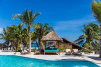 a resort pool with a gazebo and palm trees at Hotel Ojo De Agua in Puerto Morelos