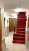 a red staircase in a building with a red carpet at Hotel San Gallo in Venice