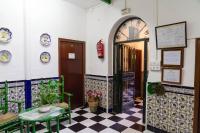 a room with a door and a checkered floor at Pensión San Benito Abad in Seville