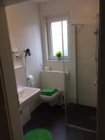 a bathroom with a toilet and a sink and a shower at Bergcafè - Hotel Kammann in Essen