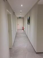 a long hallway with white walls and a tile floor at Bergcafè - Hotel Kammann in Essen