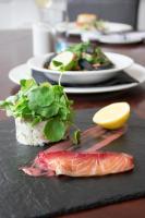 um prato de alimentos com peixes e verduras numa mesa em The Cawdor em Llandeilo