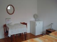 A bed or beds in a room at Vincze Vendégház