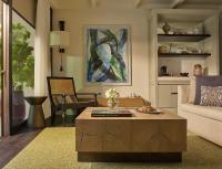 a living room with a couch and a coffee table at Rosewood Phuket in Patong Beach