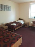 Łóżko lub łóżka w pokoju w obiekcie Hotel Paola