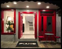 a hallway with red doors and a table and chairs at Piano Hotel in İzmir