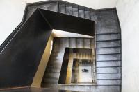 a staircase in a building with a stair case at IOTA Hotel Tbilisi in Tbilisi City