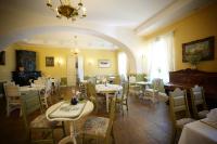 a restaurant with tables and chairs and a chandelier at Bistrampolis Manor in Kučiai