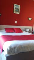 a red bedroom with a white bed with red walls at Hôtel Evian Express - Terminus in Évian-les-Bains