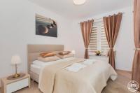 Łóżko lub łóżka w pokoju w obiekcie Grace Apartment I