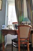 a desk with a chair and a lamp and a window at Hotel D&#39;haussonville in Nancy