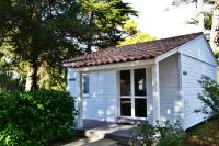 a small white shed with a tiled roof at Village Océanique in Le Bois-Plage-en-Ré