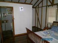 a bedroom with a bed and a light on the wall at The Funky Dodo Backpackers Hostel in Hopkins