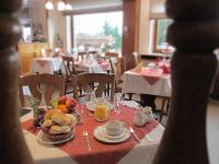 a table with a plate of food and fruit on it at Hotel Schröder in Losheimergraben
