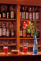a vase with flowers sitting on a table with drinks at Hotel Santa Maria in Rome