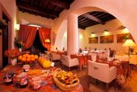 a dining room with tables and chairs with food on them at Hotel Santa Maria in Rome