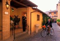 a woman on a bike next to a woman on a building at Hotel Santa Maria in Rome