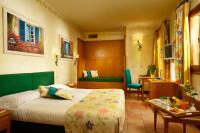 a hotel room with a bed and a desk at Hotel Santa Maria in Rome