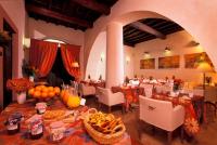 a dining room with tables and chairs with food on them at Hotel Santa Maria in Rome