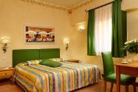 a bedroom with a bed and a desk and a window at Hotel Santa Maria in Rome