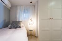 A bed or beds in a room at Apartamentos Diaber Gerona 22