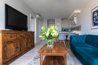 Televízia a/alebo spoločenská miestnosť v ubytovaní Apartament Świętokrzyska
