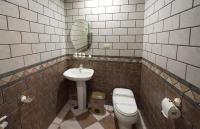 a bathroom with a sink and a toilet and a mirror at Songyuan B&amp;B in Lugu Lake