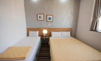 two twin beds in a small room with at Songyuan B&amp;B in Lugu Lake