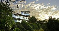 a white house with a tower on top of it at Finca Rosa Blanca Coffee Farm and Inn in Heredia