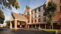 a large brick building with a parking lot in front of it at Best Western Plus Kalamazoo Suites in Kalamazoo