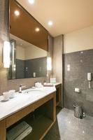 a bathroom with a sink and a large mirror at Home Hotel in Taipei