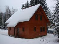 a wooden cabin with snow on top of it at Chaty Marta in Horní Bečva