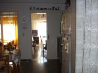 a kitchen and a living room with a refrigerator at Anna in front of the sea Apartment in Sitia