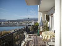a balcony with a table and chairs and a view at Anna in front of the sea Apartment in Sitia