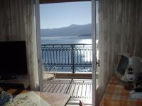 a door to a balcony with a view of the water at Anna in front of the sea Apartment in Sitia