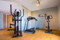 a gym with several exercise bikes in a room at The Originals City, Hôtel Acadine, Le Neubourg (Inter-Hotel) in Le Neubourg