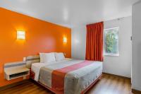 Un dormitorio con una cama grande con una pared naranja. en Motel 6-Baraboo, WI - Lake Delton-Wisconsin Dells, en Baraboo